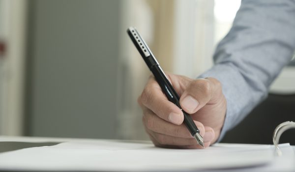 Close Up Of Businessman Signing A Contract.